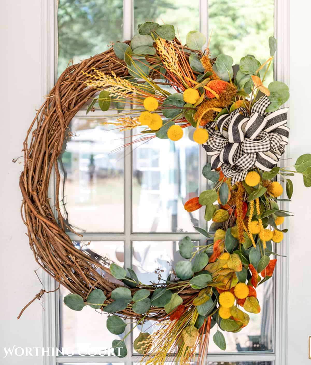 diy fall grapevine wreath with traditional fall colored picks