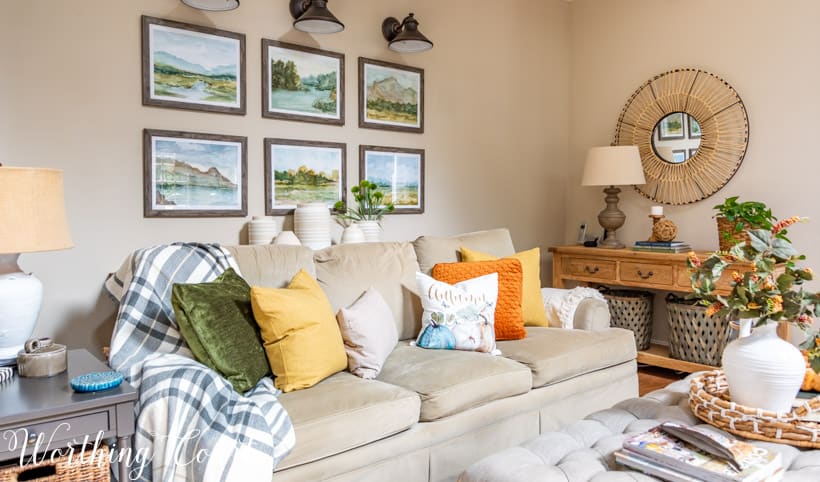 Neutral sofa filled with fall colored throw pillows