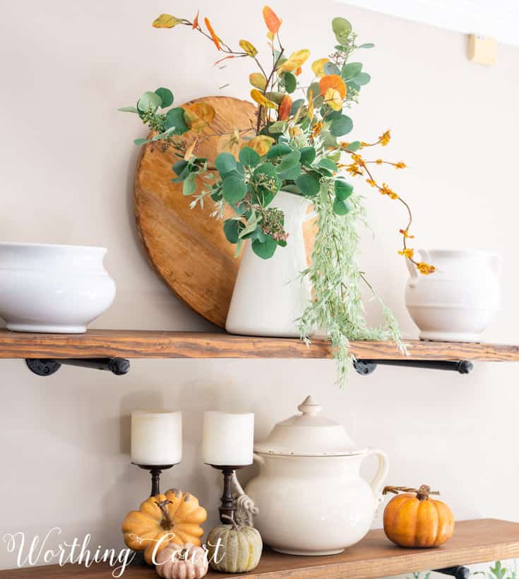 fall decorations on open shelves