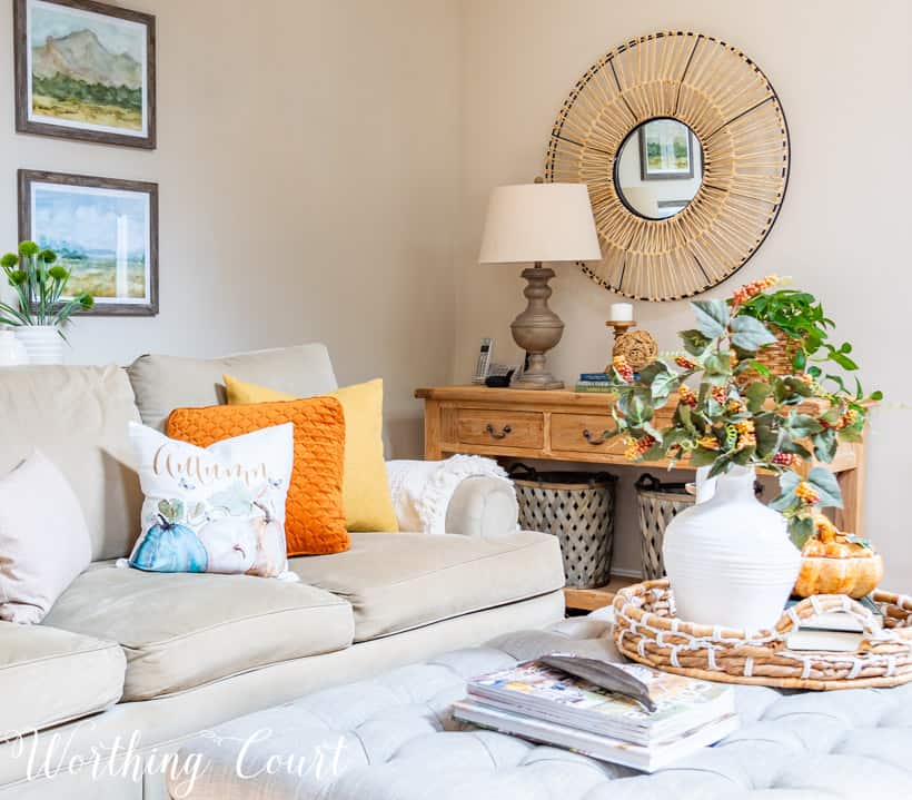 Neutral sofa with fall pillows and a console table with fall decor