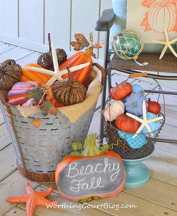 Bucket and basket filled with a variety of pumpkins for a coastal fall vibe.