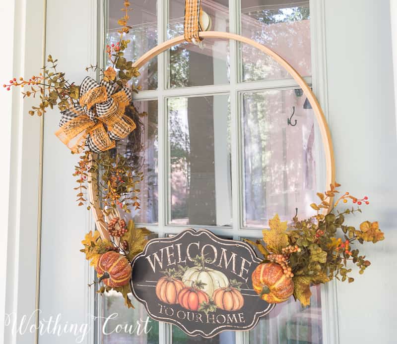 Fall wreath made using an embroidery hoop with a welcome to our home sign.