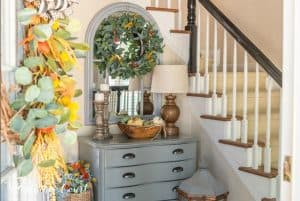 foyer with gray chest topped with fall decor