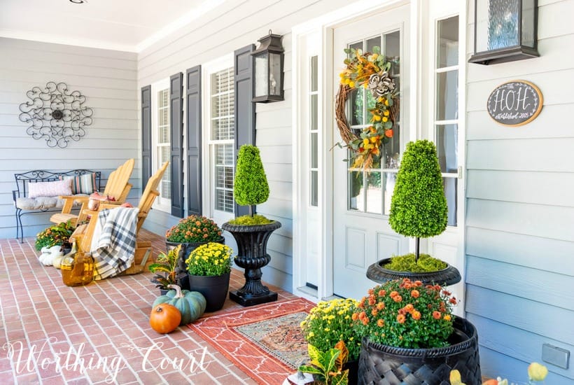 front porch decorate for fall with mums and pumpkins