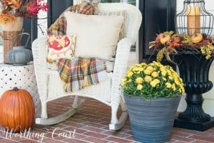 white wicker rocking chair with fall pillows