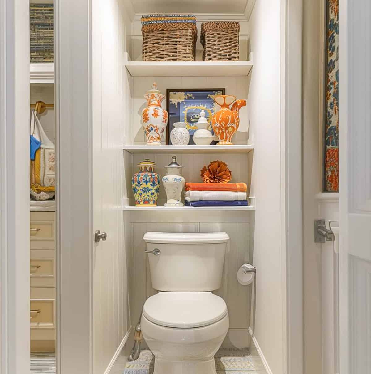 white shelves above a toilet decorated with bathroom type accessories