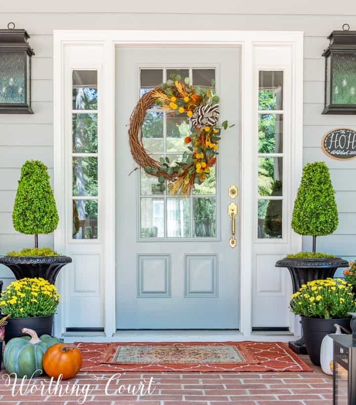 front porch decor ideas including a front door with a fall wreath