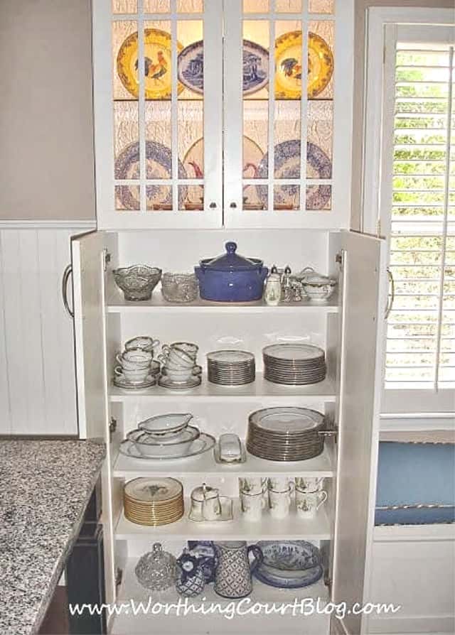 The bottom of the cabinet contains dishes.