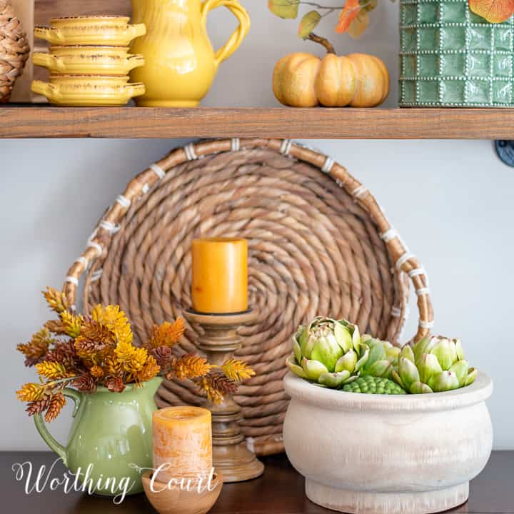 easy fall vignette with fall colored accessories on a sideboard
