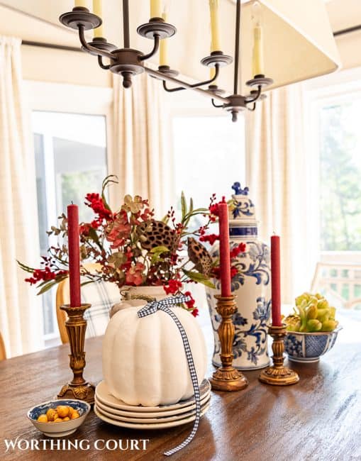 easy fall centerpiece idea with a white pumpkin and blue and burgundy accessories