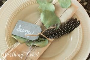 neutral place setting with eucalyptus napkin ring