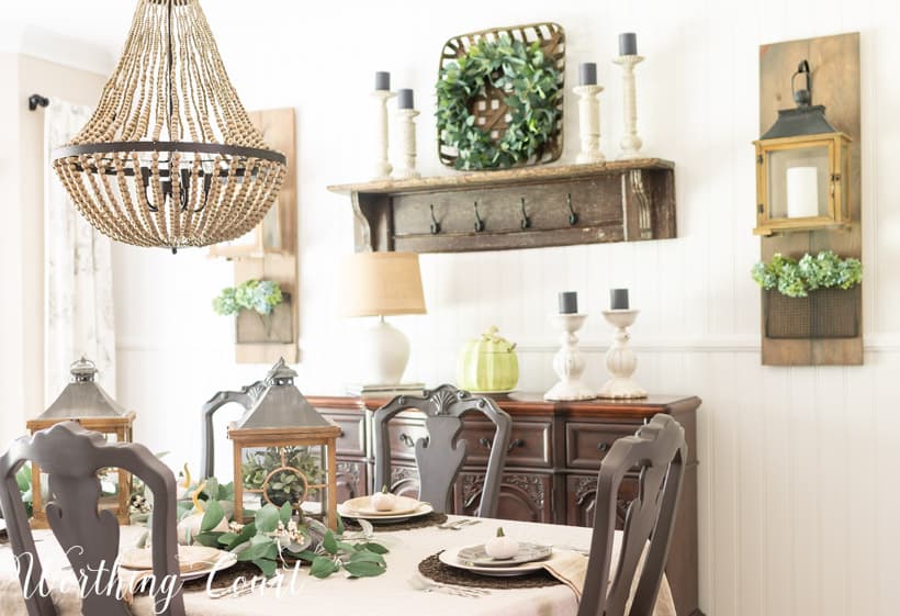 dining room table set for Thanksgiving with neutral dishes and linens