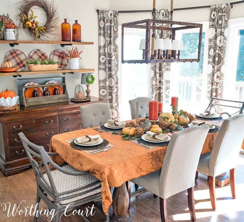 Thanksgiving table and open shelves decorated for fall
