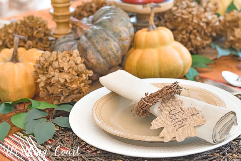 Thanksgiving table with fall colors and neutral dishes