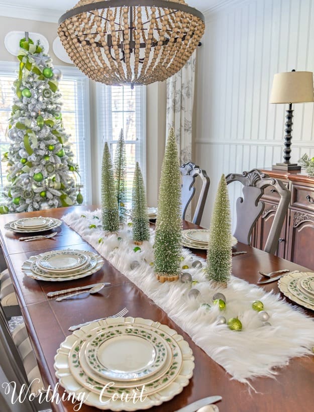 Christmas table centerpiece with a faux fur runner and bottlebrush trees.