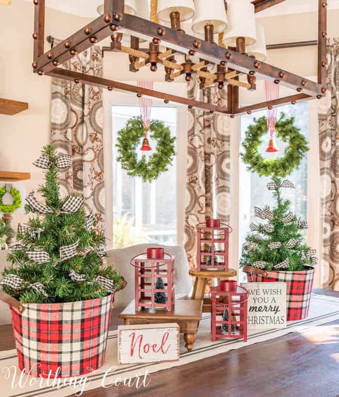 There is a wood and metal light fixture above the table.