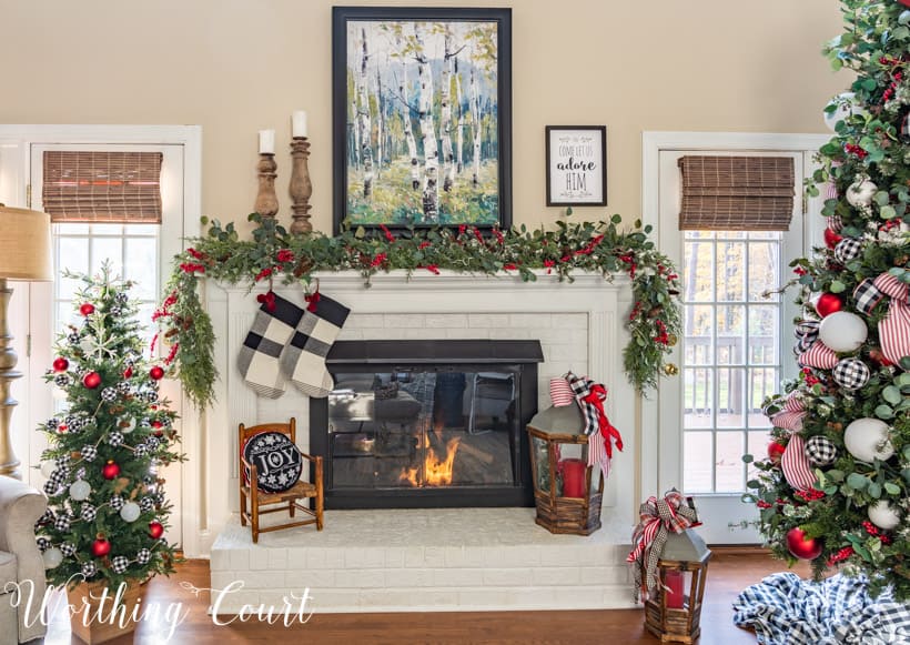 There is a large painting above the fireplace mantel.