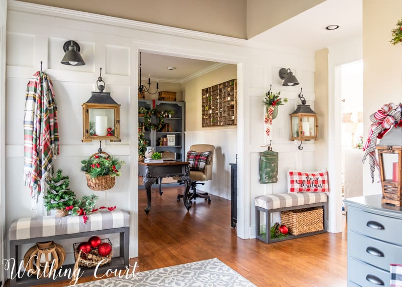 Board and batten wall with Christmas decorations hanging from the hooks.