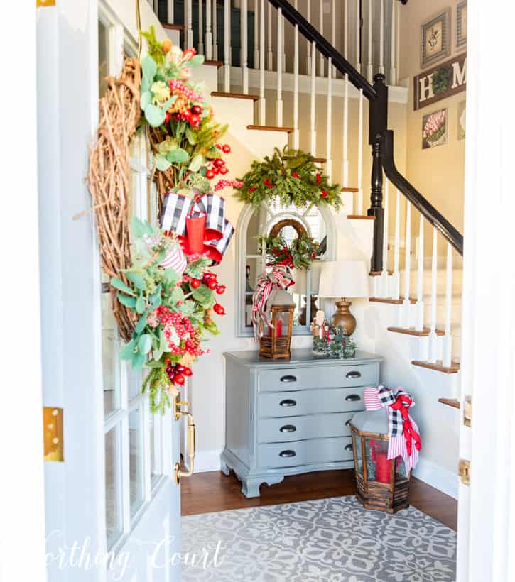 A view from front door looking into foyer decorated for Christmas.