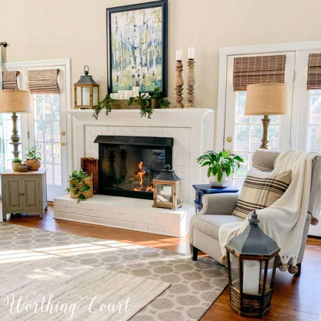 white brick fireplace with winter decor