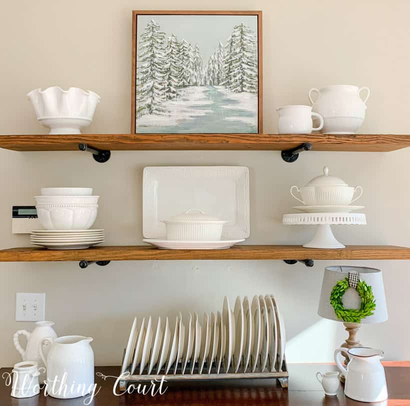 open shelves decorated for winter with white accessories