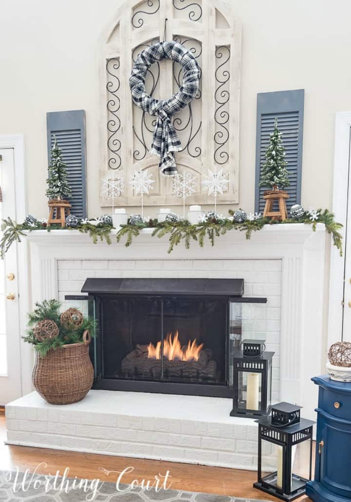 White brick fireplace decorated for winter. 