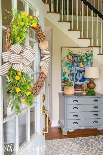 looking through a front door into a foyer with spring decor