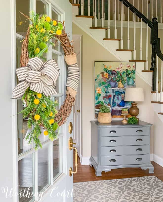 looking through a front door into a foyer with spring decor