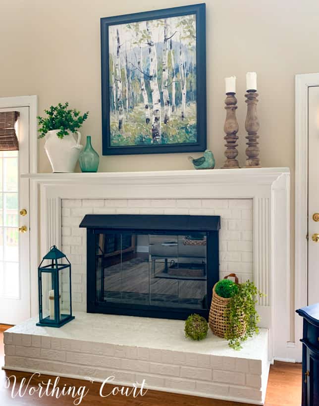 White fireplace with spring decorations.