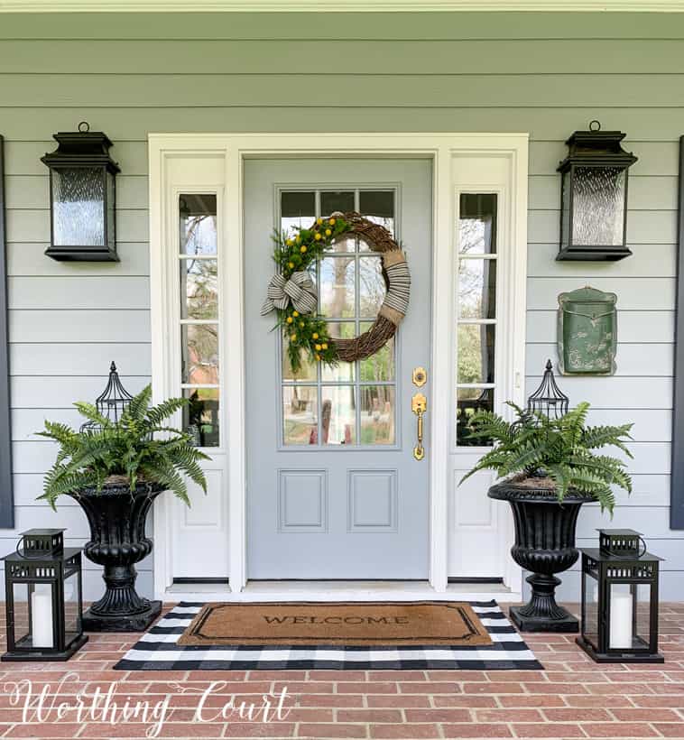 A grapevine wreath is on the front door.