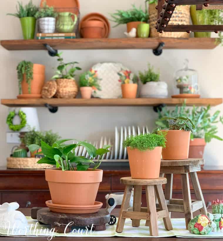 table centerpiece with terra cotta pots and greenery displayed at different levels