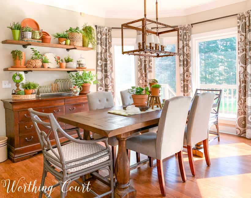 breakfast room with table, chairs and open shelves decorated for spring