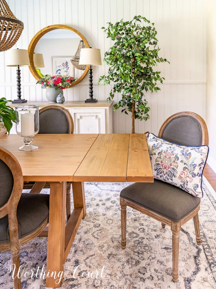 gray chair at end of dining table