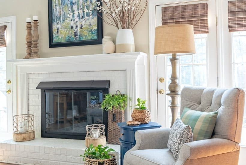 gray recliner beside white painted brick fireplace