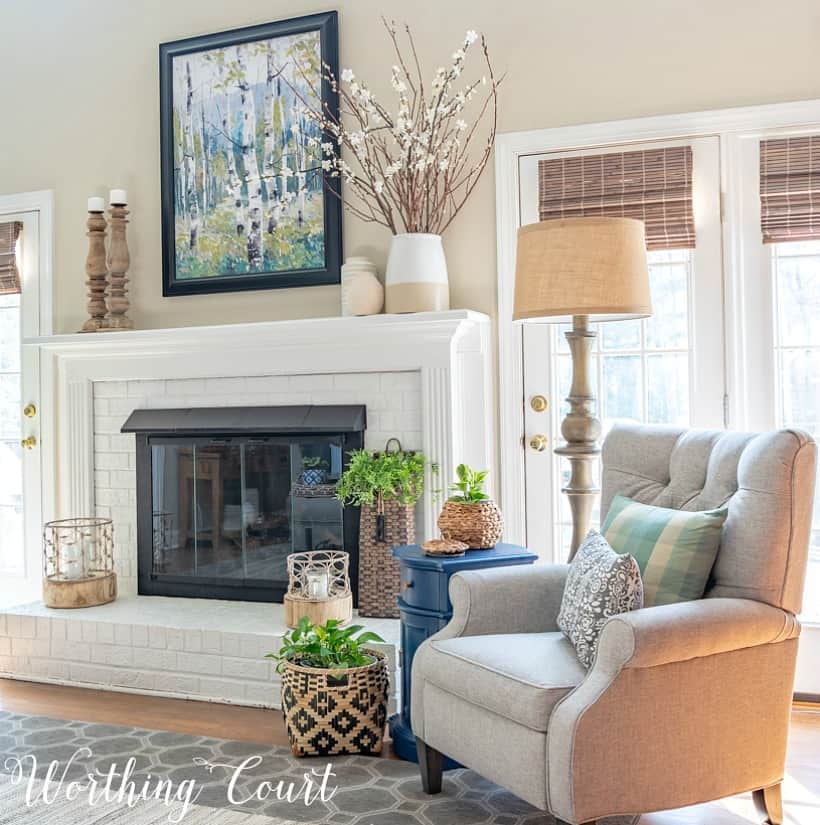 gray recliner beside white painted brick fireplace