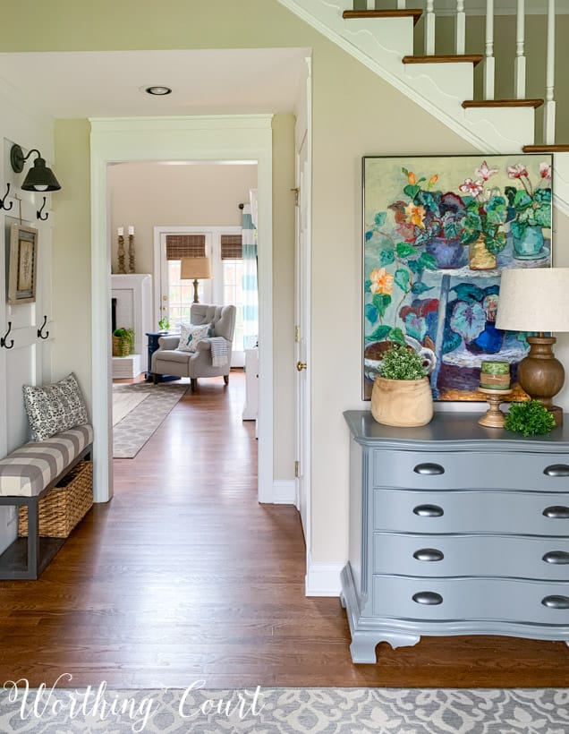 Entryway with colorful painting looking through to family room.