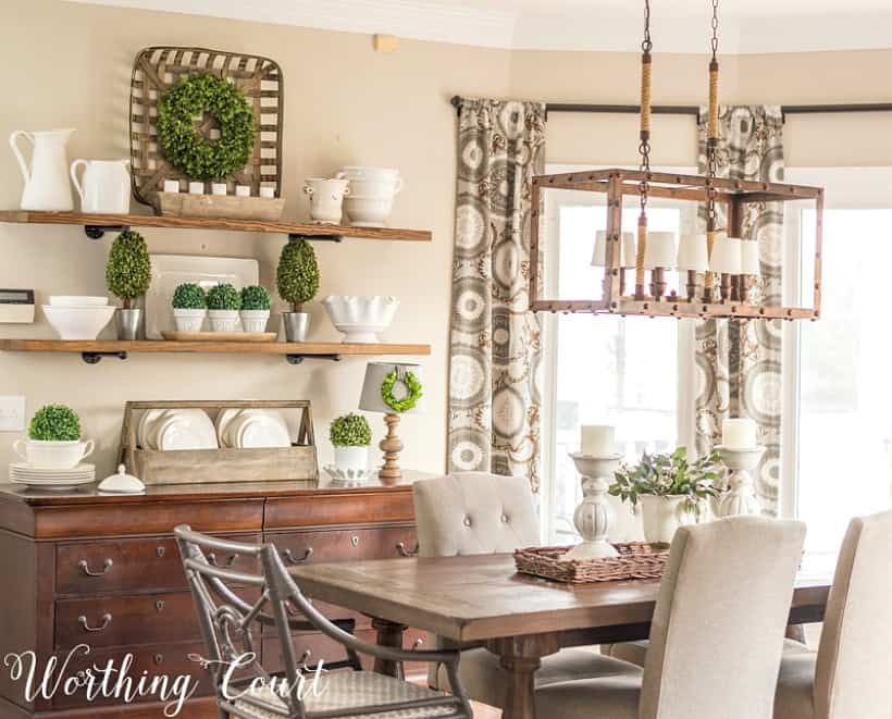 Breakfast room with table, chairs and open shelves decorated for spring.