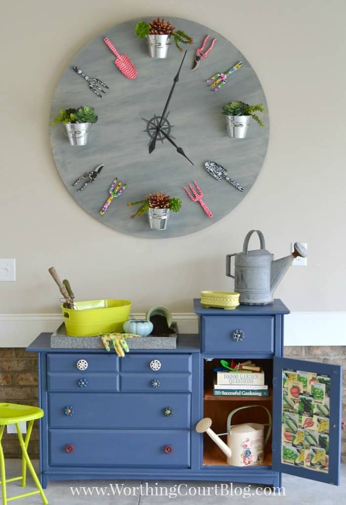 huge diy clock above blue garden bench