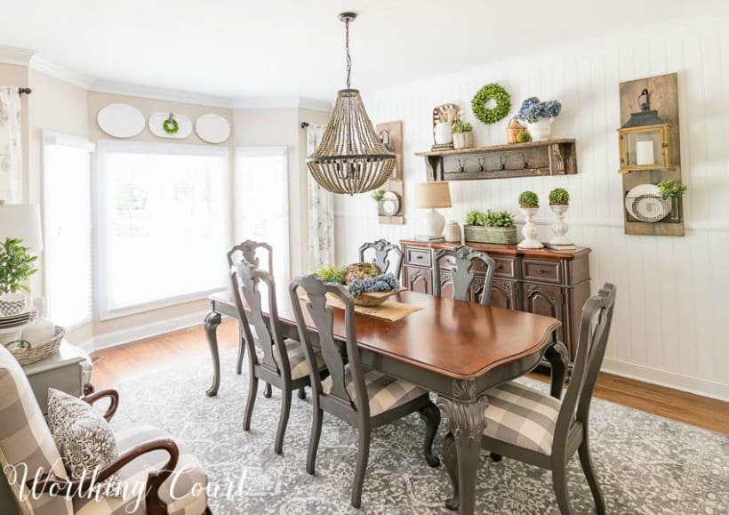 dining room with gray and wood table, chairs and sideboard