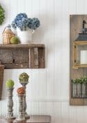 white paneled wall with hanging lantern and vintage shelf display