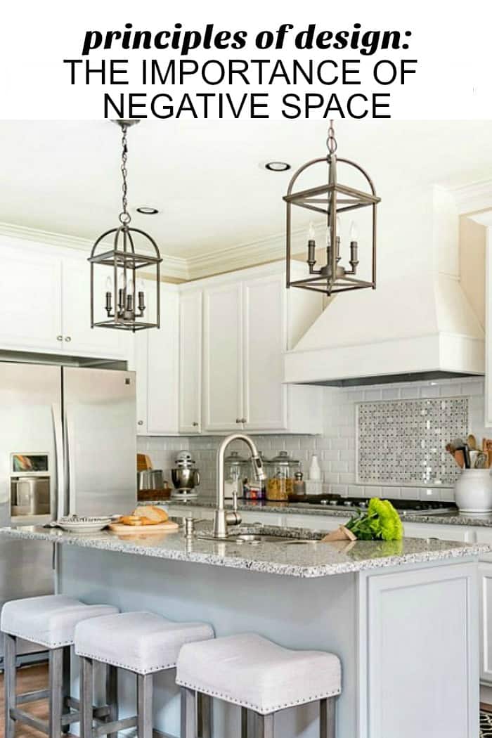 pinterest image of white kitchen showing negative design space
