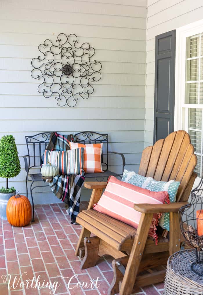 front porch with Adirondack gliders decorated for fall