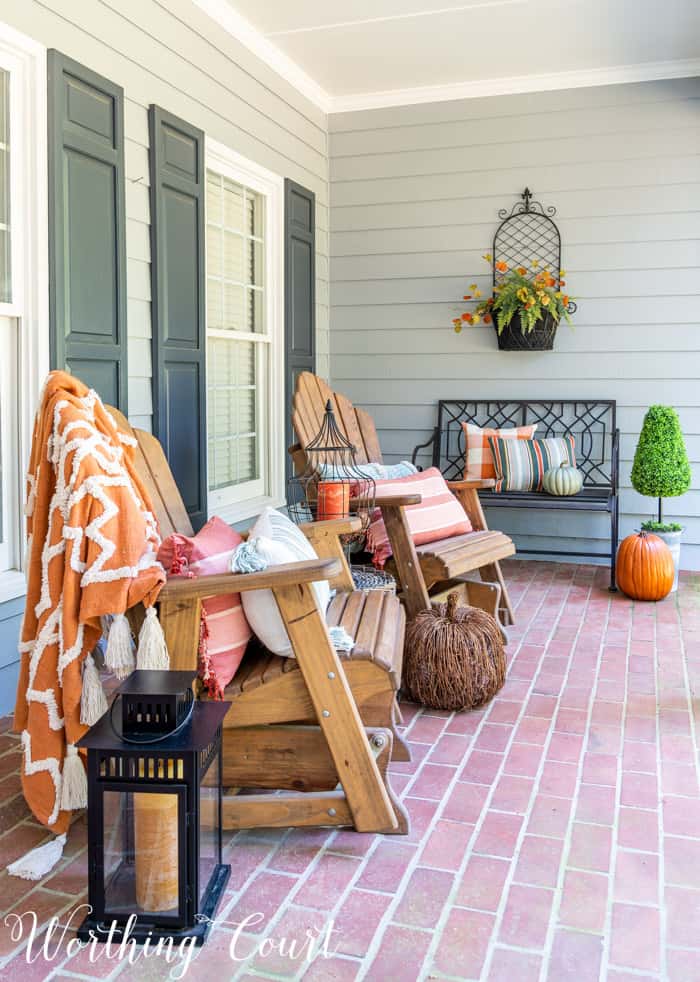 front porch with Adirondack gliders decorated for fall