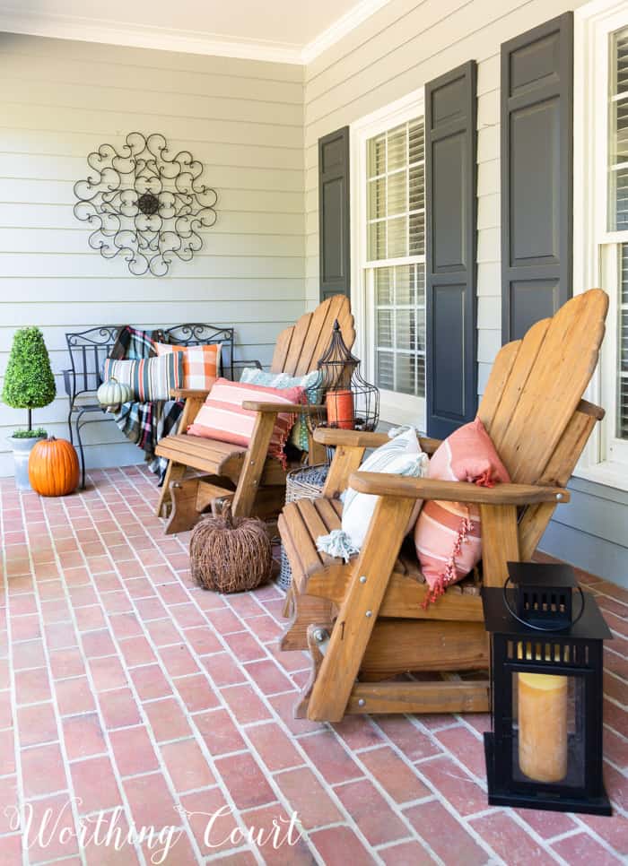 front porch with Adirondack gliders decorated for fall