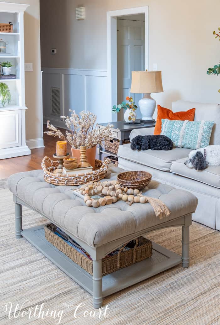 upholstered coffee table decorated for fall