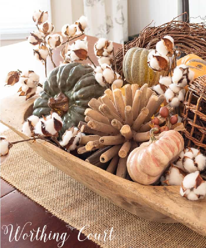 wood bowl filled with a variety of fall items