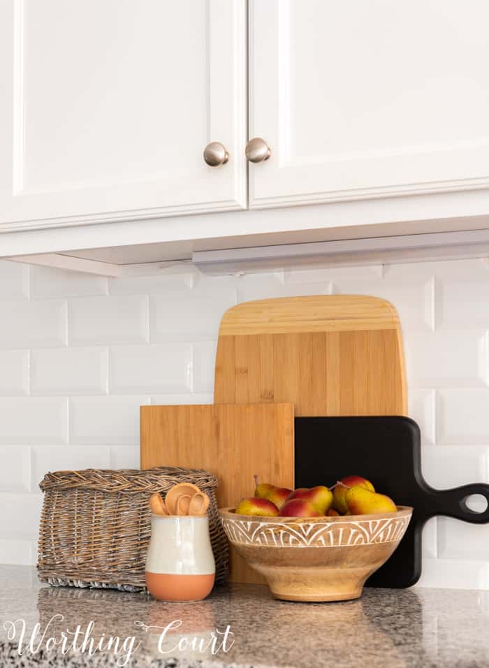 fall decor in kitchen with white cabinets and granite counters