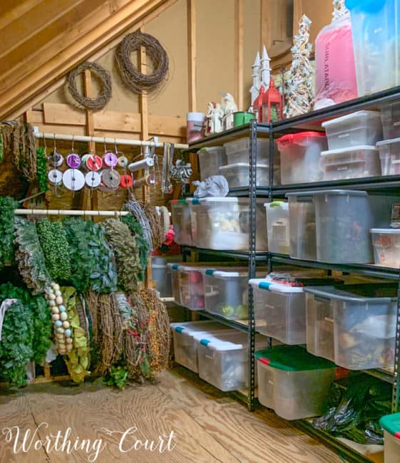 plastic storage bins on shelves in attic