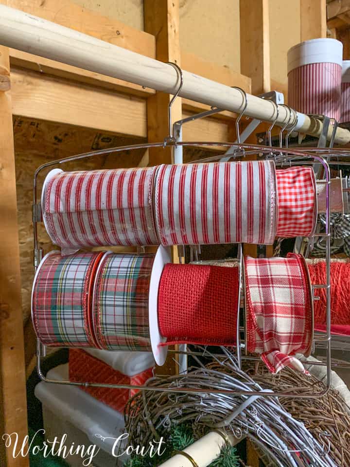 Ribbon rolls stored on pants hanger in the attic.