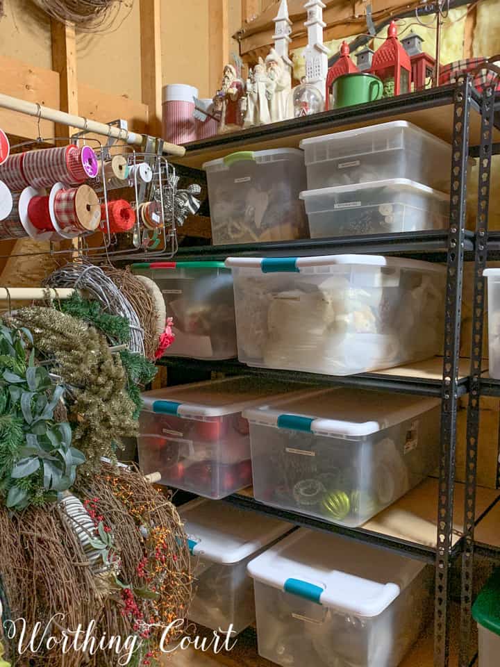 plastic storage bins on shelves in attic